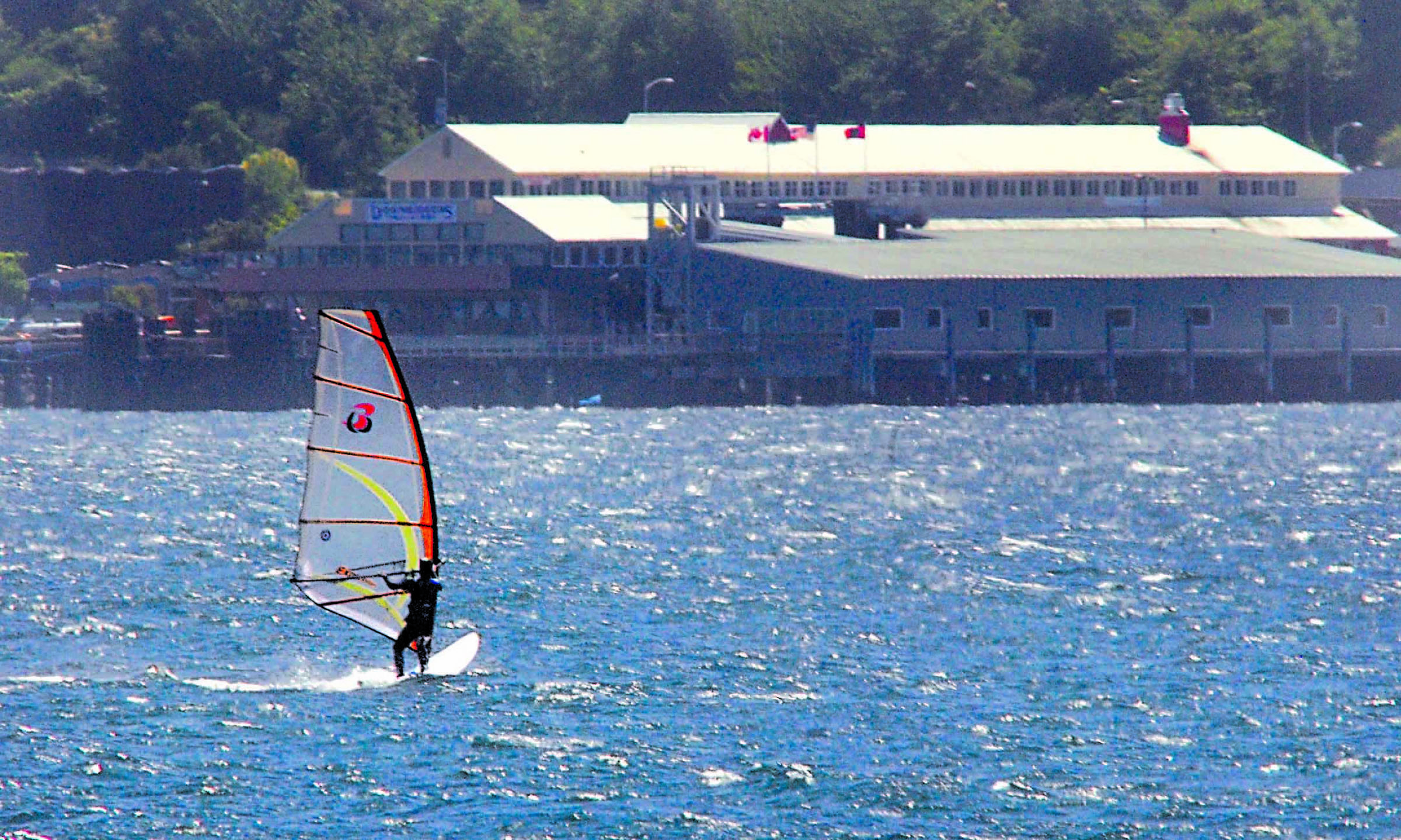 Against a backdrop of The Landing mall and the Black Ball Ferry terminal