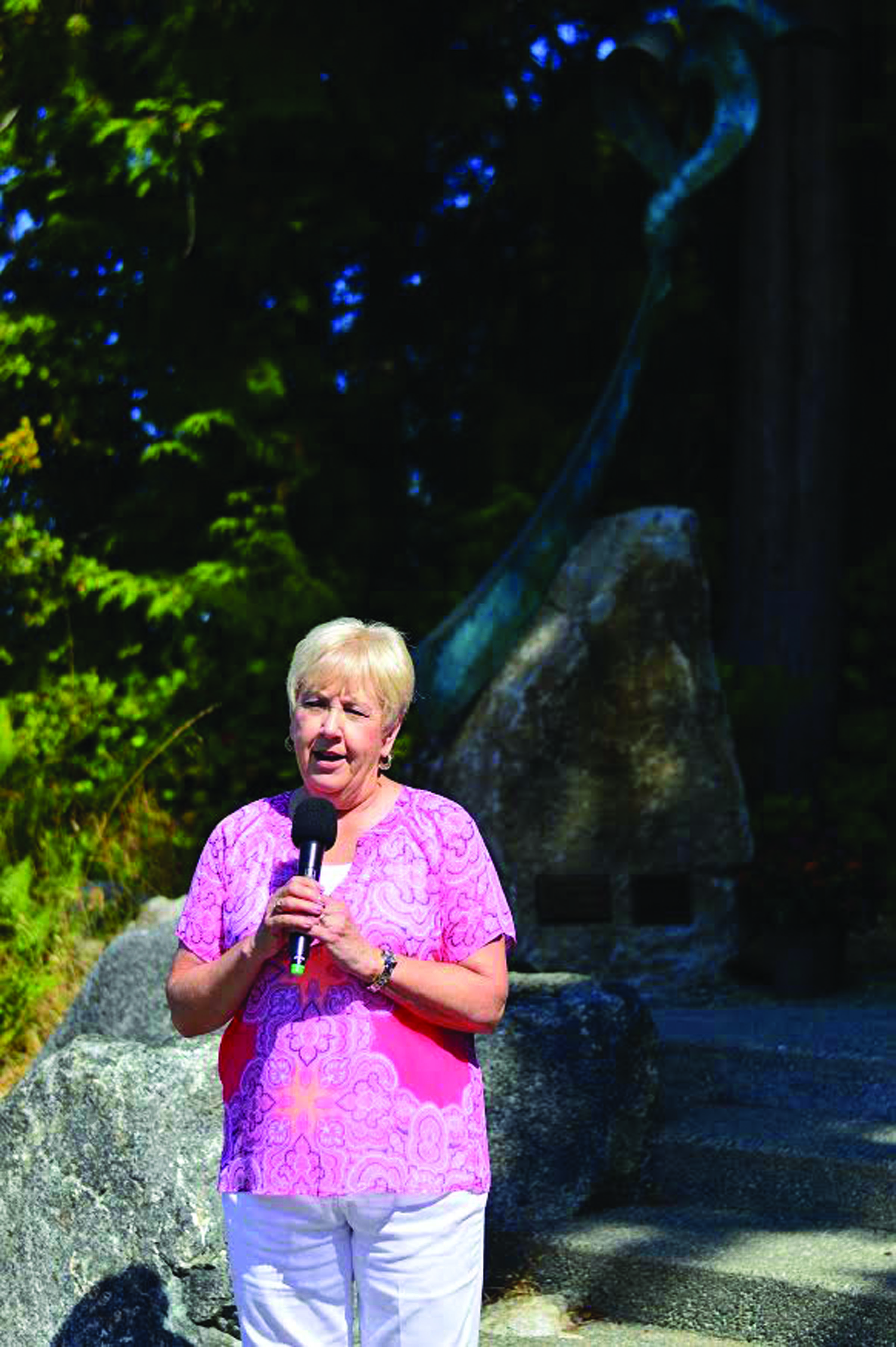 Port Angeles Fine Arts Center foundation president Phillis Olson speaks at the entrance to Webster's Woods