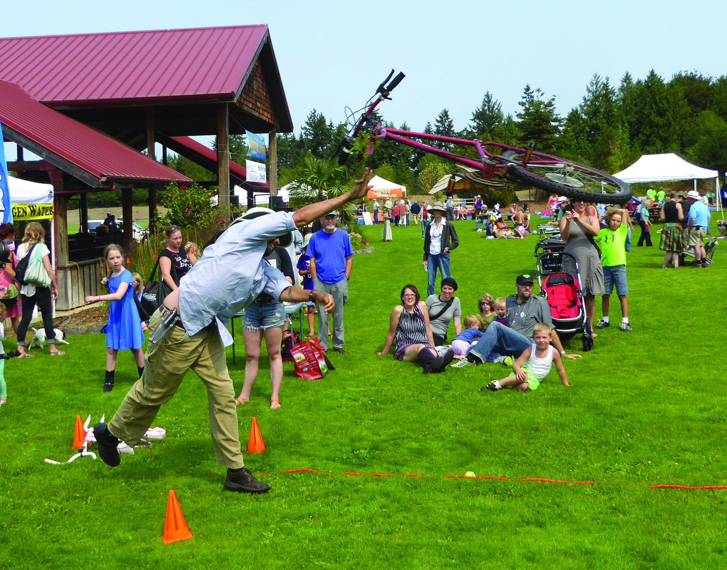 Damian Wright of Port Townsend participates in a bicycle toss at the All County Picnic on Sunday in Chimacum. Wright threw the bike more than 19 feet. — Charlie Bermant/Peninsula Daily News