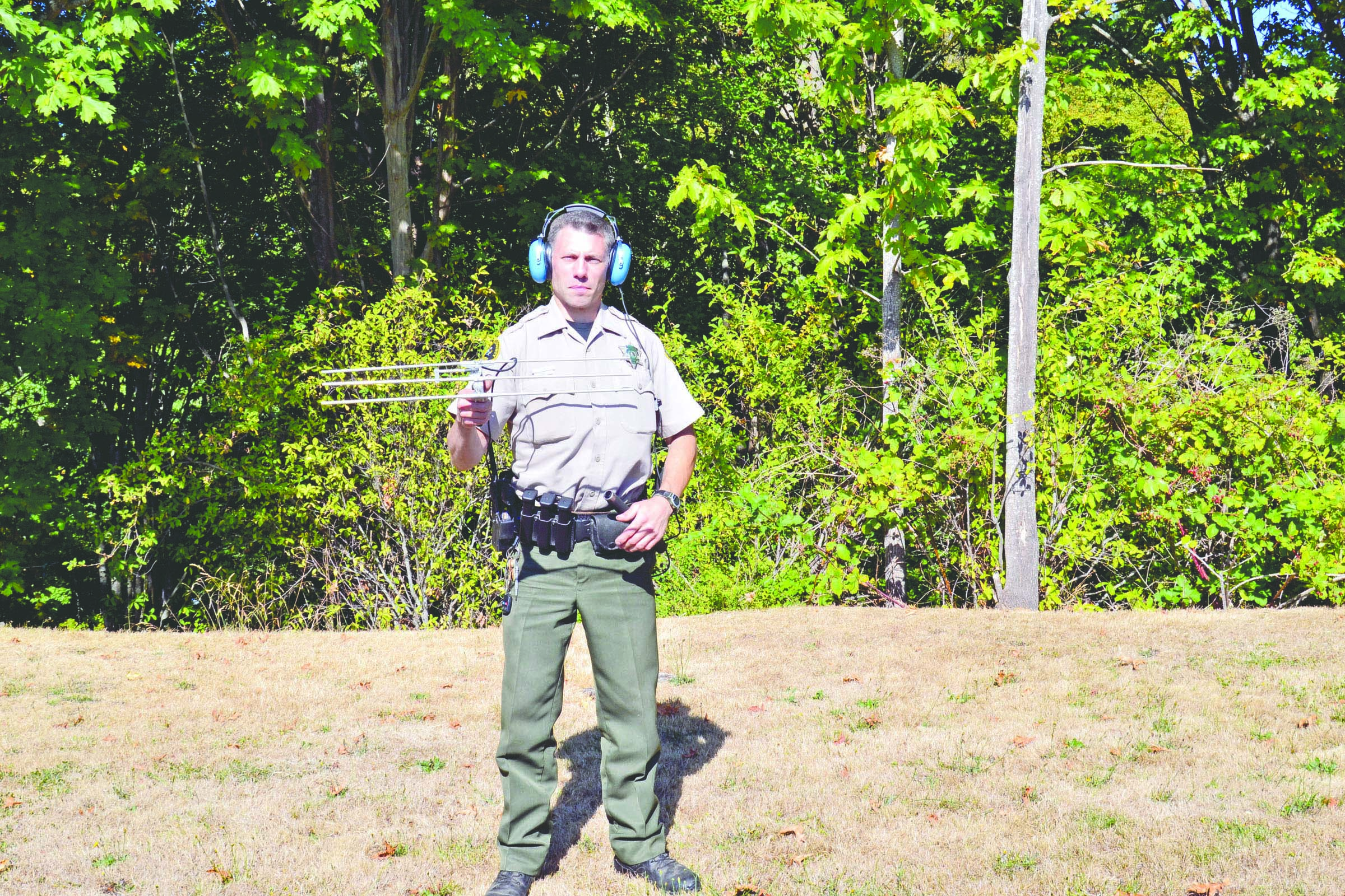 Clallam County Sheriff's Deputy Josh Ley demonstrates how to use a Project Lifesaver receiver designed to pick up signals from small transmitters worn by clients with cognitive disabilities. Clallam County Sheriff's Office