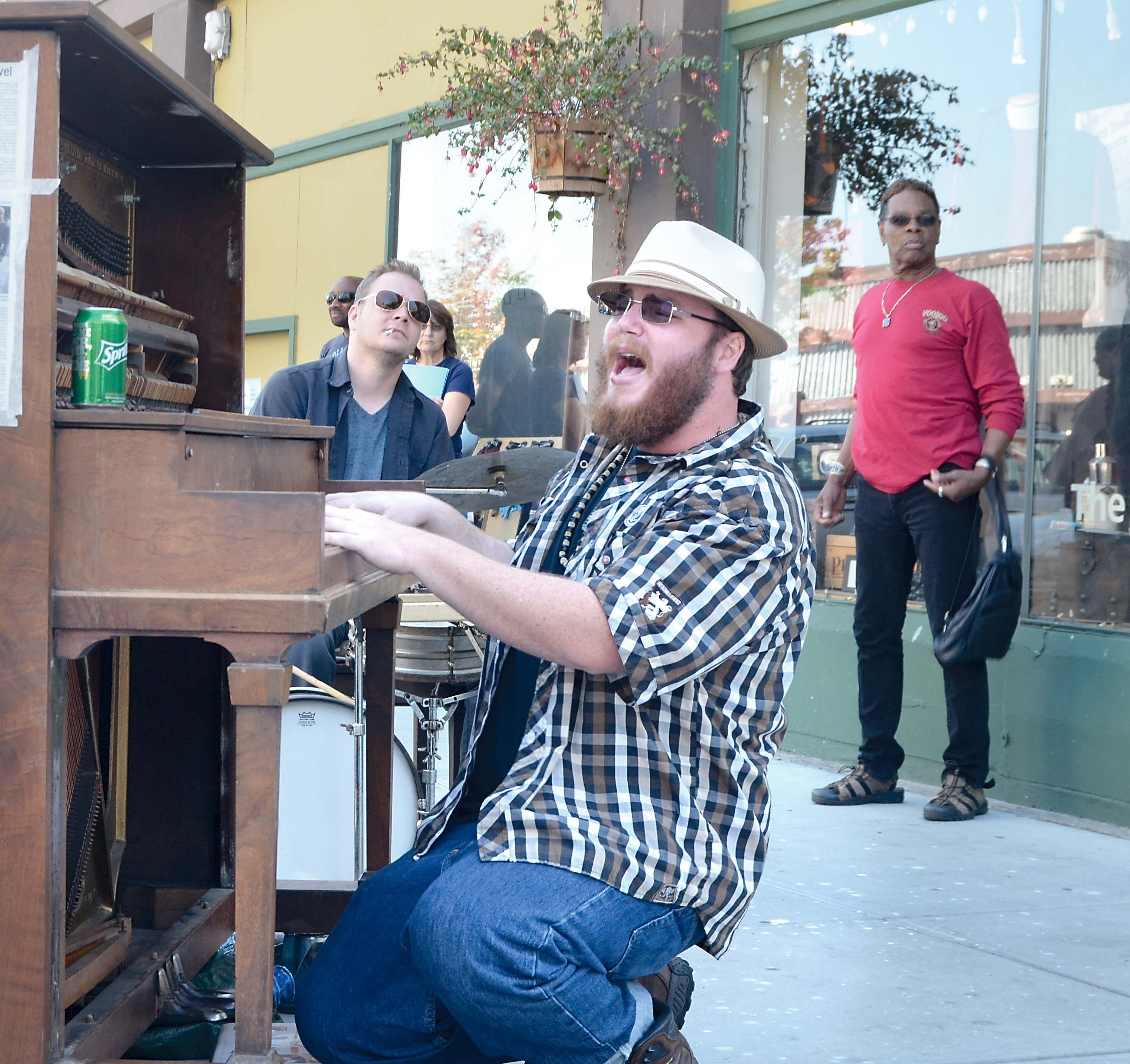 Chris Flowers pounds out a Jerry Lee Lewis tune on the Port Townsend community piano Thursday afternoon. Also pictured is drummer Aaron Fowler and passerby Lee Brown. — Charlie Bermant/Peninsula Daily News