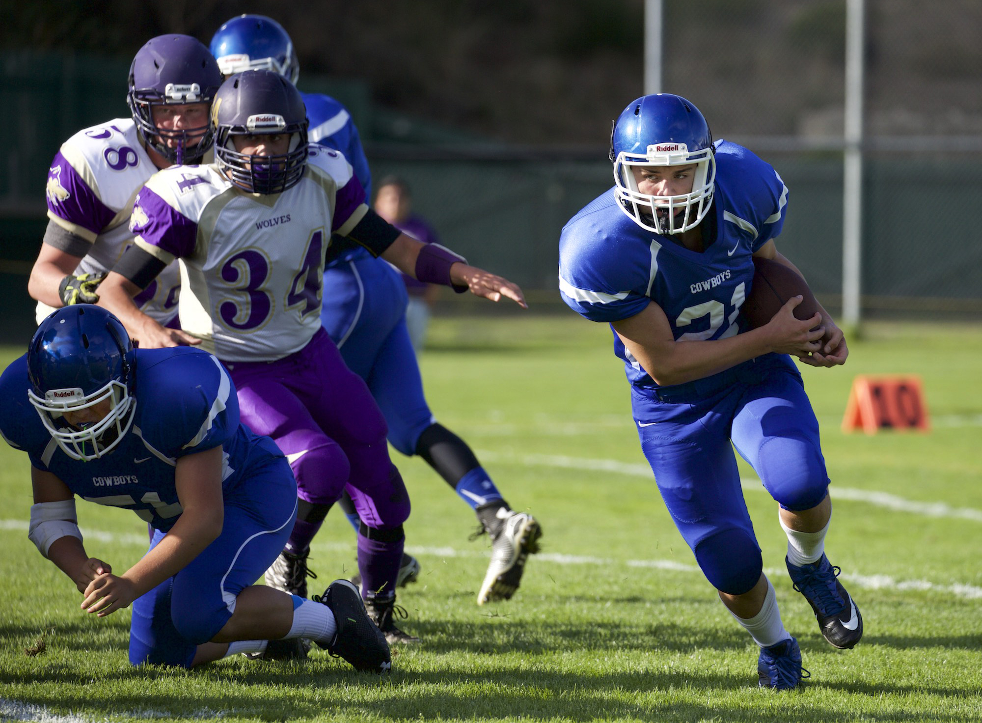 Chimacum's Elijah Avery runs around a block by teammate Aaron Serrato against Sequim last week at Memorial Field in Port Townsend. Steve Mullensky/for Peninsula Daily News