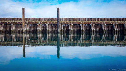 This photo of pilings in Port Angeles Harbor by artist Viola Ware will be one of the pieces of art featured at Karon's Frame Center