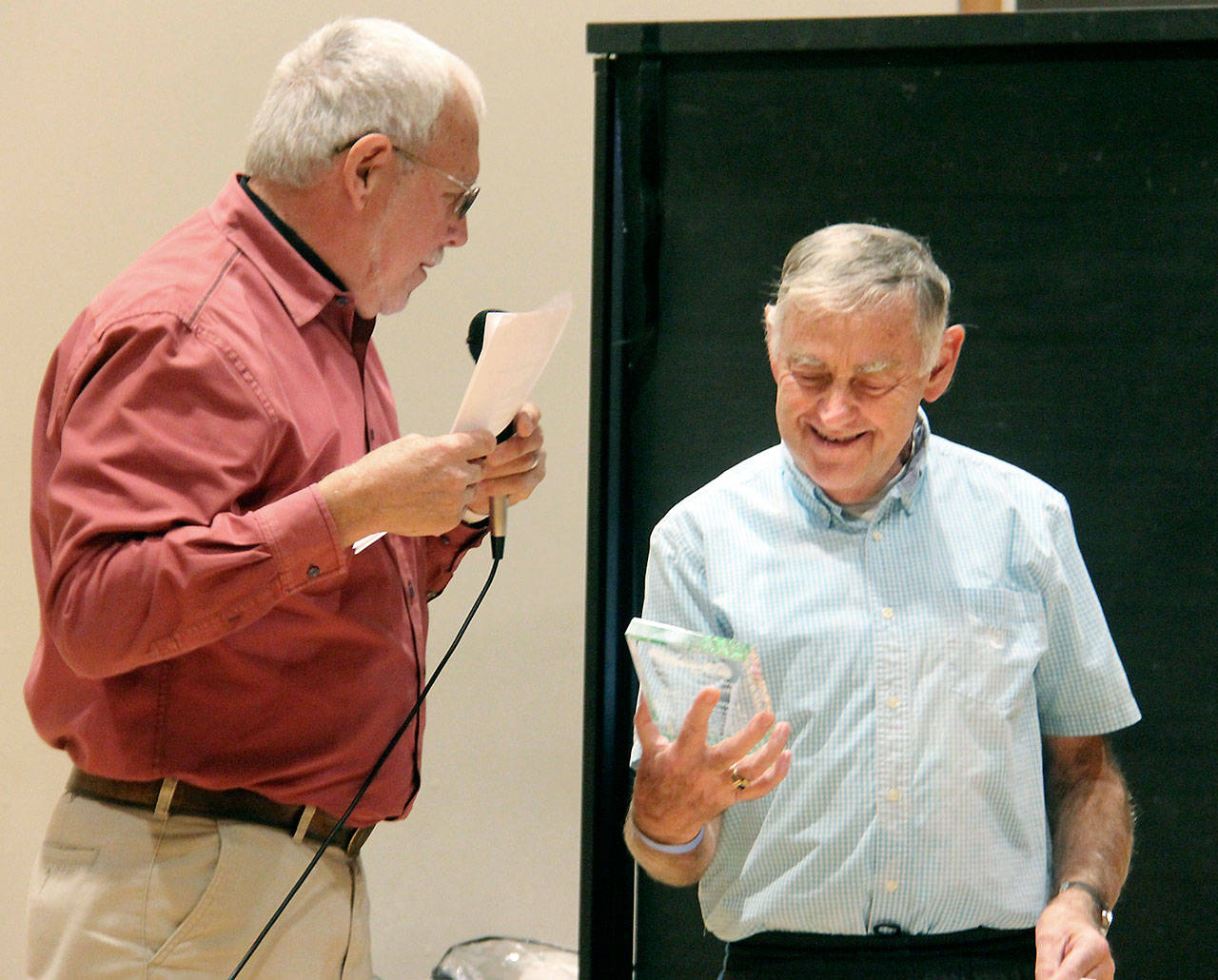 Lonnie Archibald accepts the Forks Citizen of the Year award from master of ceremonies John Calhoun.