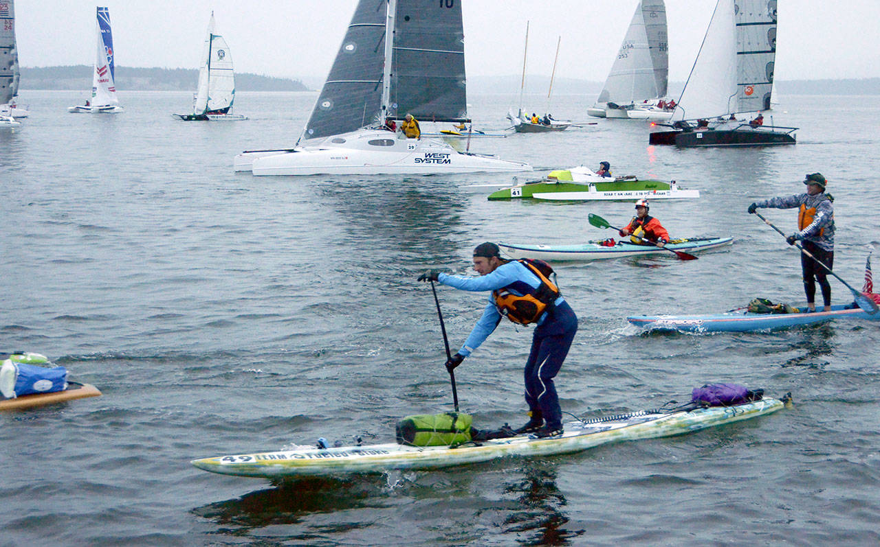 Paddle boarder Luke Burritt of team Fueled on Stoke takes off at the start of the 2017 Race to Alaska. Burritt, along with his teammate, stopped at Dungeness Spit to camp for the night before making the crossing to Victoria. (Cydney McFarland/Peninsula Daily News)