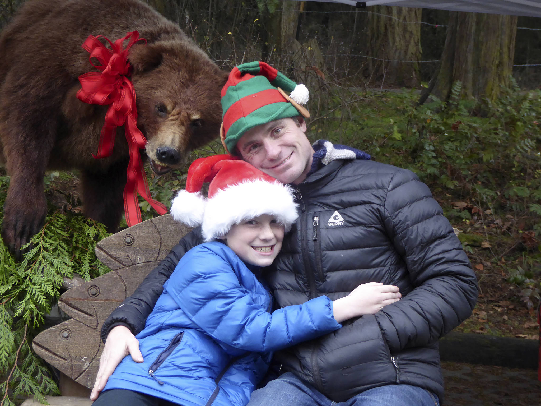 Powell Jones, Dungeness River Audubon Center director, and his son, Win, pose with some river center animals. The 11th annual River Center Holiday Nature Mart is set for today and Saturday.