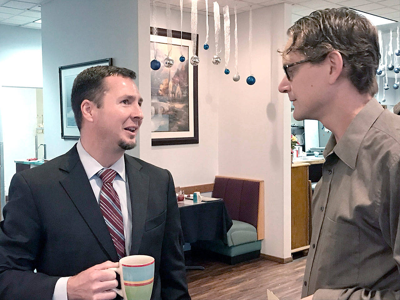 Clallam County Prosecuting Attorney-Coroner Mark Nichols talks with City Council member-elect Lindsey Schromen-Wawrin at a Port Angeles Business Association meeting Tuesday. (Paul Gottlieb/Peninsula Daily News)