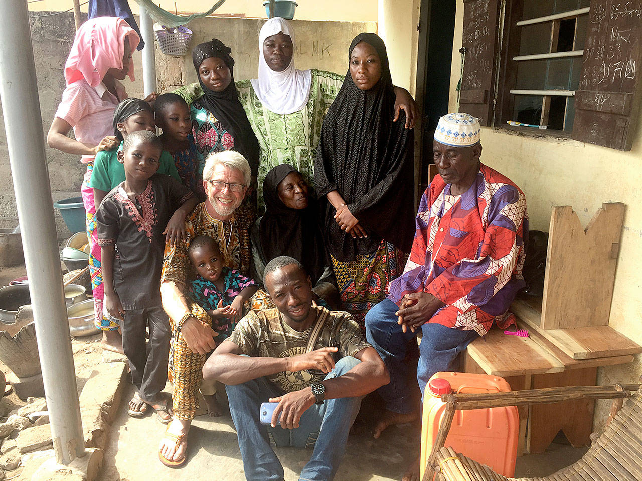 Doc Reiss poses with members of Taouvik Boukari’s family. Standing at top left is Taouvik’s sister, Boudia, and her four children. To Boudia’s left are Taouvik’s sisters Ameeda and Smiah. Standing to the right of Smiah is Taouvik’s second mother Nime’. Reiss is seated with Taouvik’s mother Fousema. Tao’s father, Salaj, is seated on the bench and Taouvik is in front.