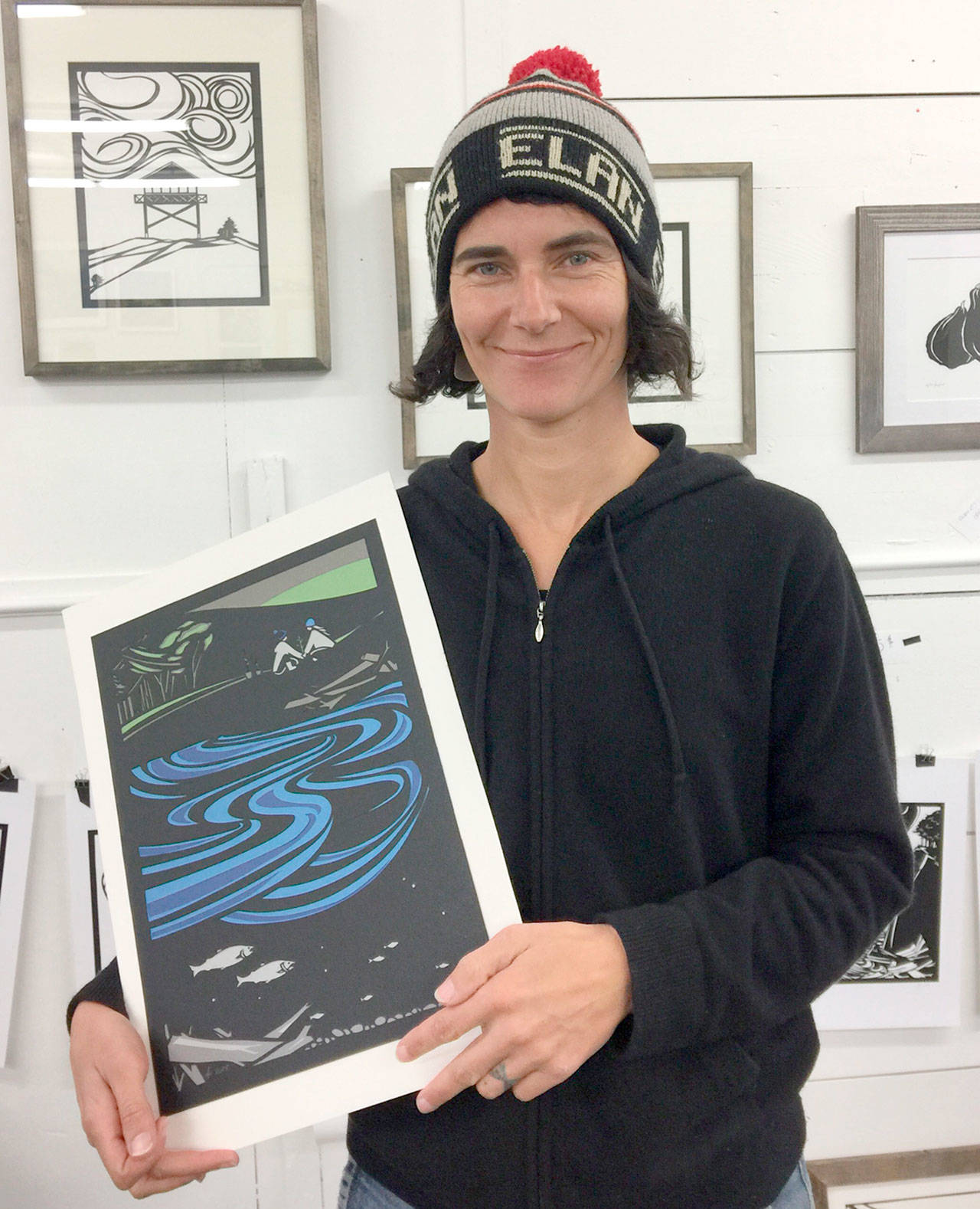 Hannah Viano holds “A New Generation,” which graces this year’s Honorary Tree Cards. Bids are being accepted now for the framed original.