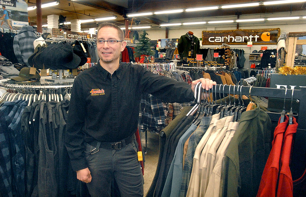Swain’s General Store manager Don Droz stands in the mens clothing department on Wednesday as his store is readied for Black Friday, the traditional beginning of the holiday shopping season. (Keith Thorpe/Peninsula Daily News)