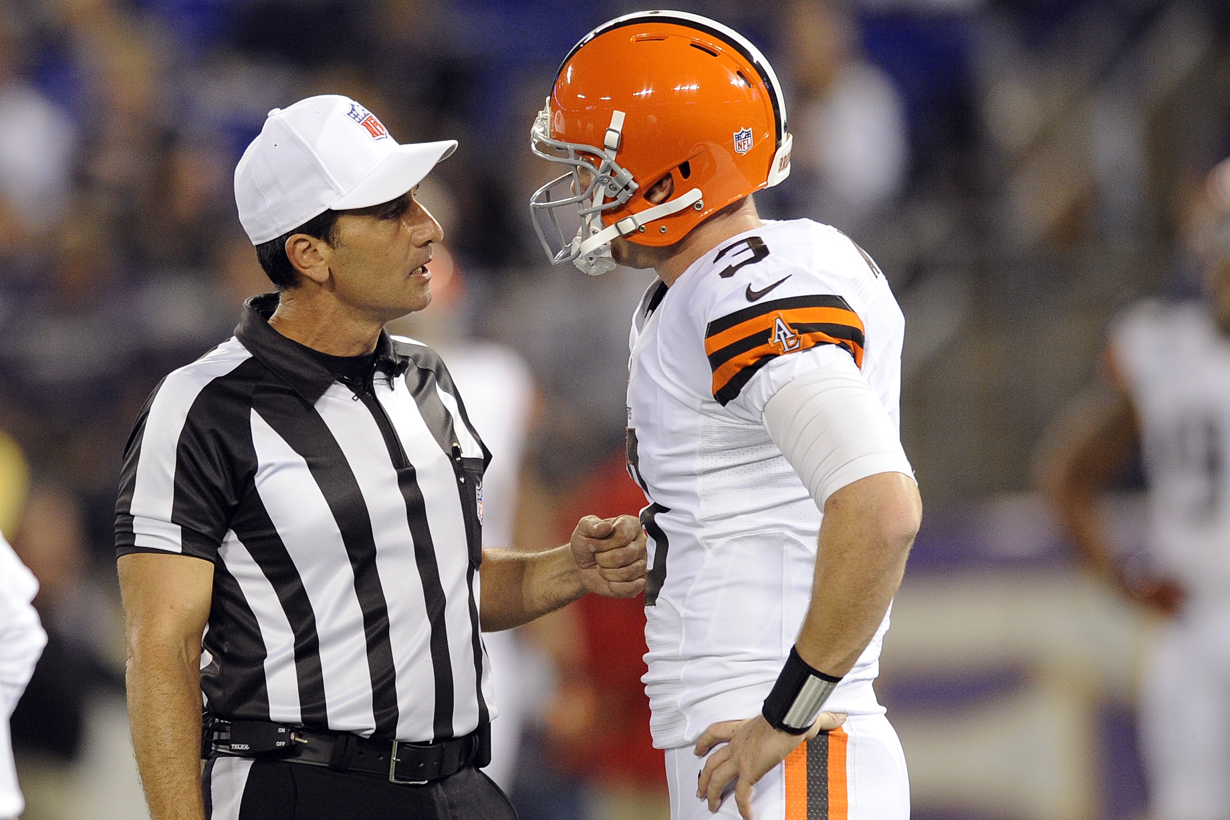 Referee Gene Steratore talks with Cleveland Browns quarterback Brandon Weeden before an NFL football game against the Baltimore Ravens in Baltimore on Thursday. The Associated Press