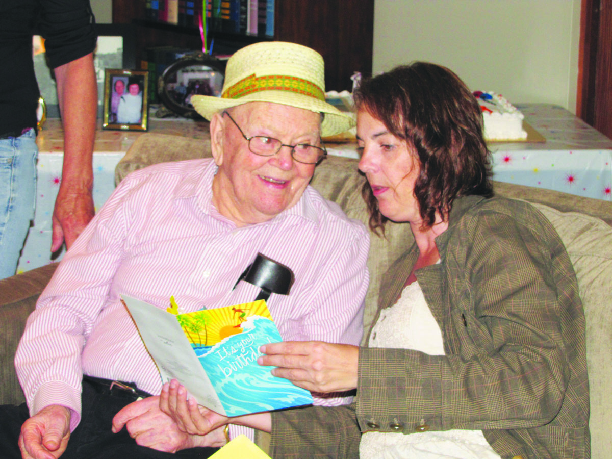 Edgar Edwards sits with granddaughter Shadee Roderick of Port Angeles at his 101st birthday party Sunday in Port Angeles. Arwyn Rice/Peninsula Daily News