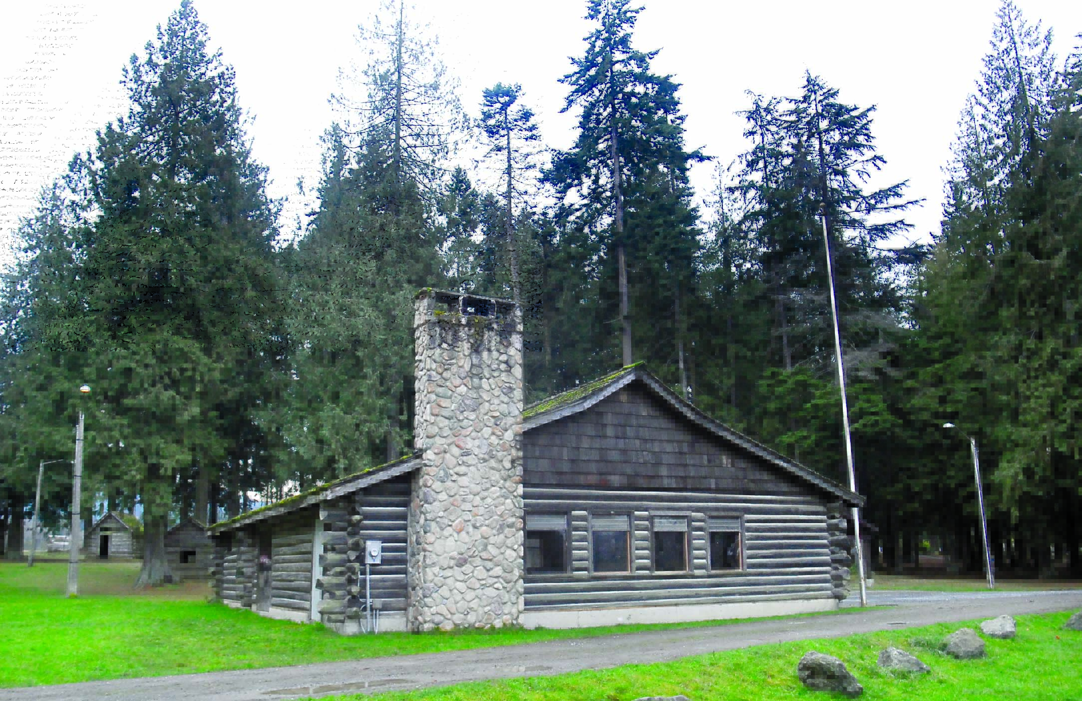 The historic Loomis Tavern building in Port Angeles' Lincoln Park sits next to a stand of trees that PABA members would like to see cut to clear the landing approach for the nearby William R. Fairchild International Airport. Keith Thorpe/Peninsula Daily News