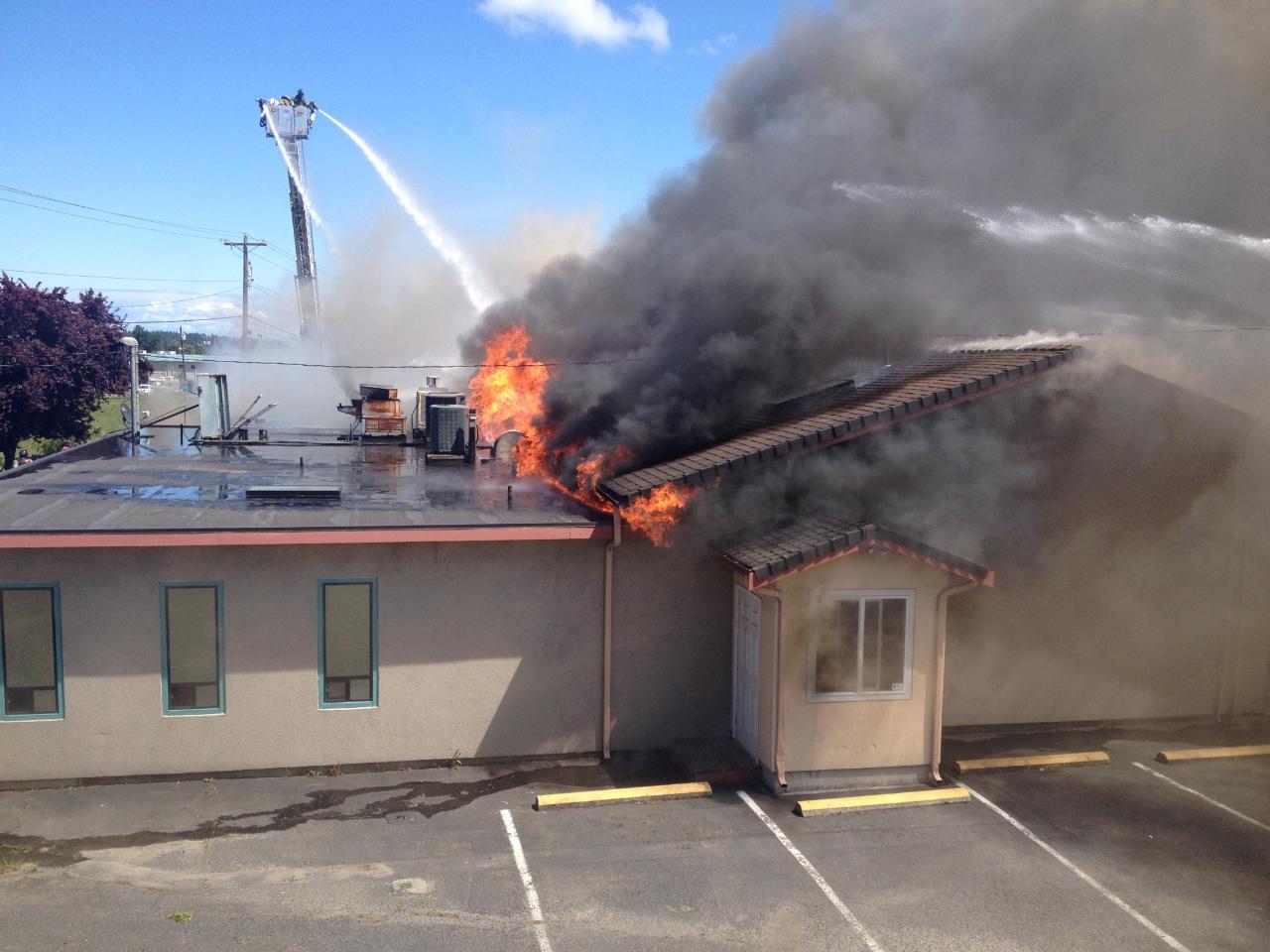 Firefighters try to control a structure fire Monday afternoon at Baja Cantina in Sequim. Joe Smillie/Peninsula Daily News