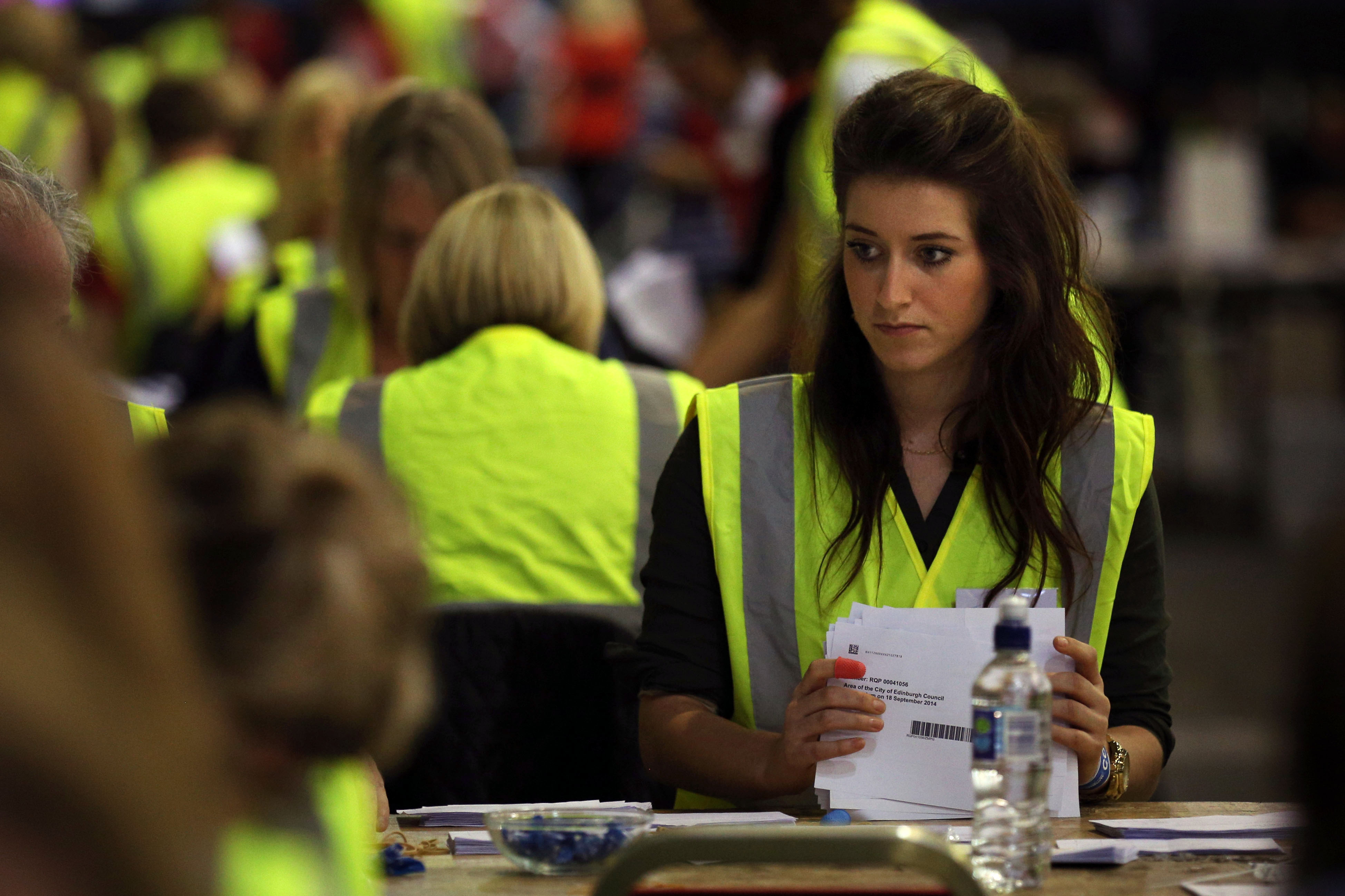 Ballot boxes are opened as counting begins in the Scottish Independence Referendum at the Royal Highland Centre in Edinburgh