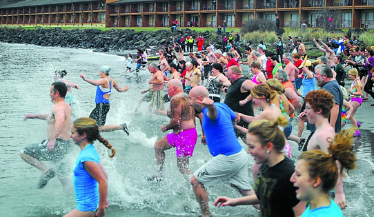 A crowd rushes into the water Tuesday morning from Hollywood Beach in Port Angeles. Keith Thorpe/Peninsula Daily News