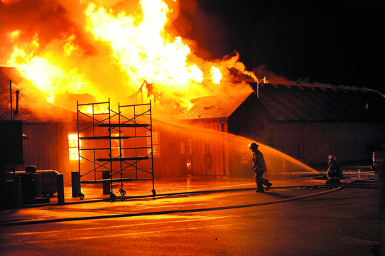 Members of Clallam County Fire District No. 1 battle the blaze at a Department of Natural Resources building in Forks early Wednesday. Lonnie Archibald/for Peninsula Daily News