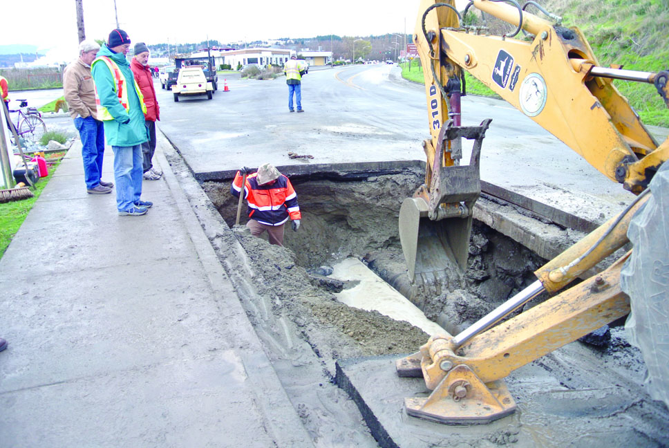 Crews work to fix the broken water main in front of the Tides Inn on Water Street in Port Townsend on Sunday. Charlie Bermant/Peninsula Daily News