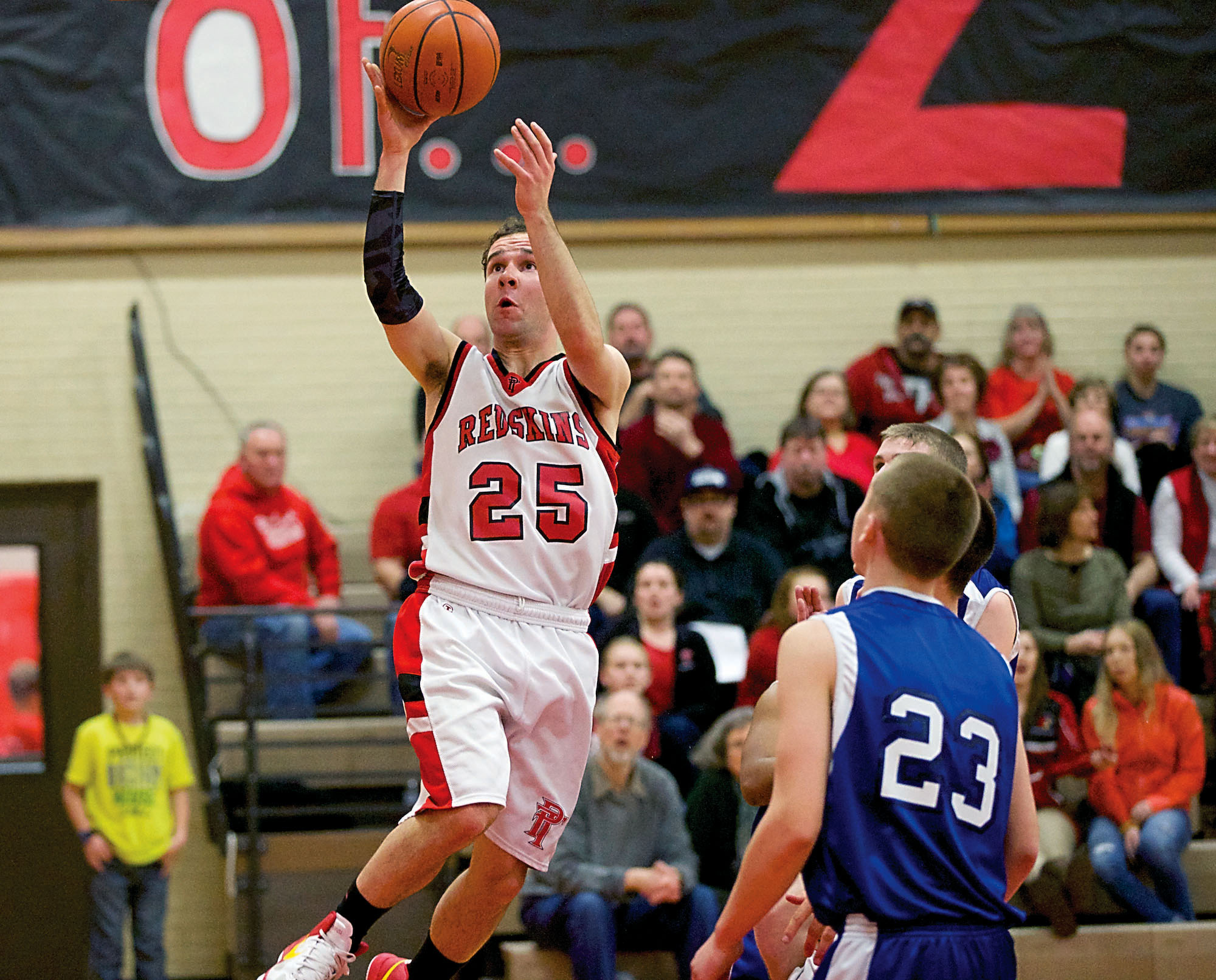 Port Townsend's Daniel Charlton takes to the air for a basket against Chimacum at Port Townsend High School. The Redskins won 58-33. Steve Mullensky/for Peninsula Daily News