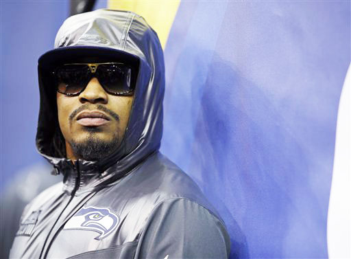 Seattle Seahawks' Marshawn Lynch stands against a wall during media day for the NFL Super Bowl XLVIII football game in Newark