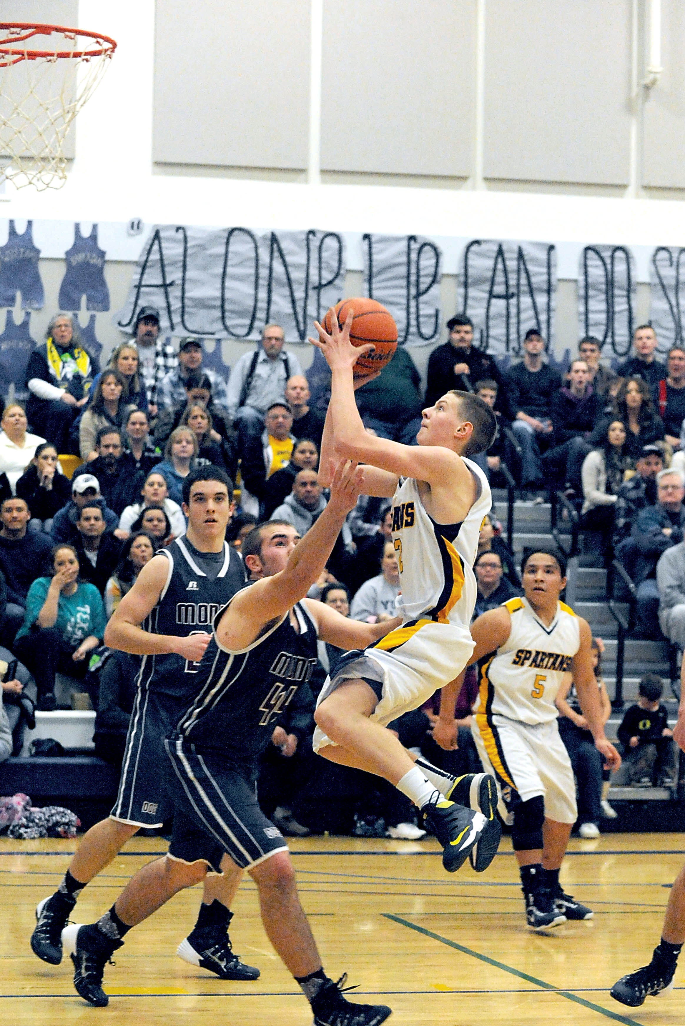 Forks freshman Parker Browning scores over Montesano's Kenny Roy (20) and Evan Bialkowsky (44). Lonnie Archibald/for Peninsula Daily News