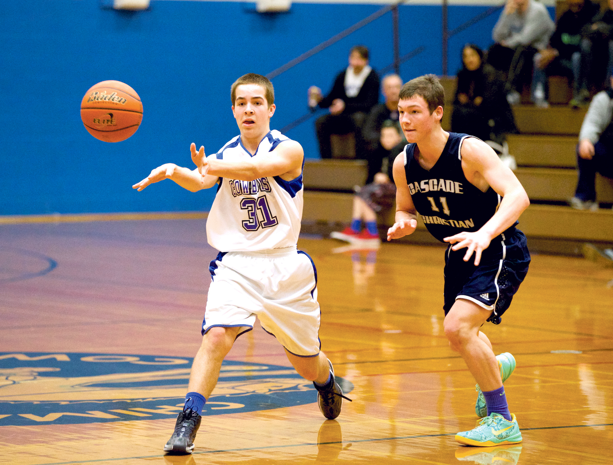 Chimacum's Christopher Bainbridge passes the ball to a temmate as Cascade Christian's Jesse Howelis applies pressure. Steven Mullensky/for Peninsula Daily News