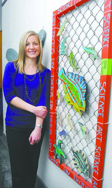 Feiro Marine Life Center board member Morgan Fox stands next to a "Fish on the Fence" display in Port Angeles. Keith Thorpe/Peninsula Daily News