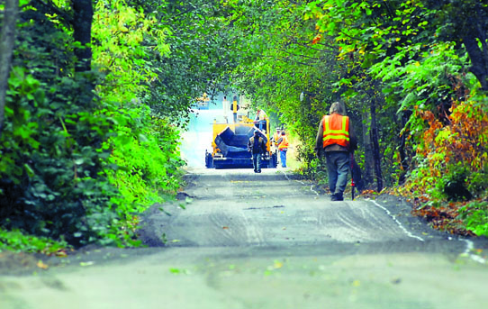 A crew waits for the next truck of asphalt during a project to pave sections of the Olympic Discovery Trail on the west side of Port Angeles last September. Keith Thorpe/Peninsula Daily News