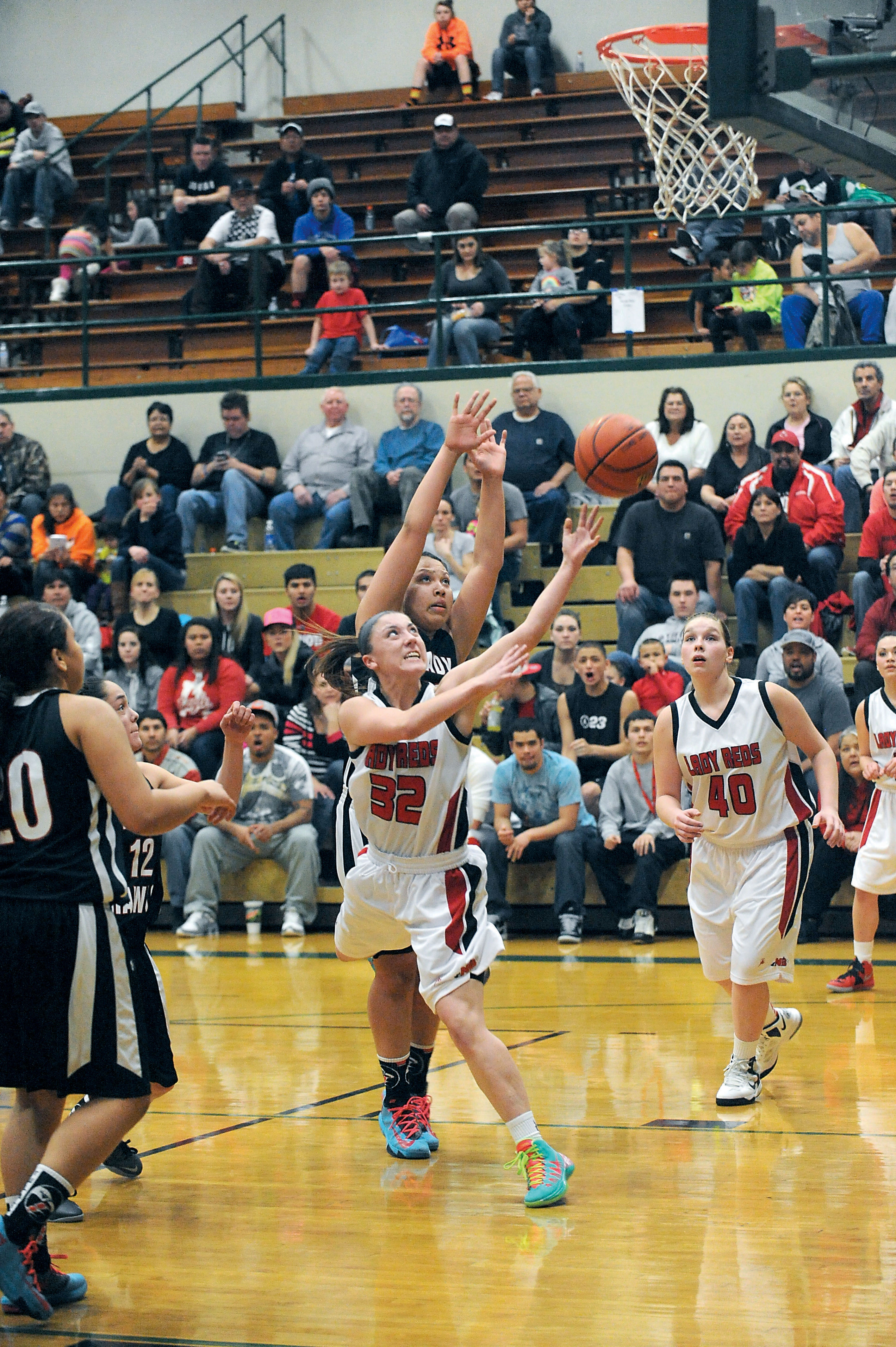 Neah Bay's Cierra Moss (32) puts up a shot around Tulalip Heritage's Aliya Jones while Neah Bay's Blaire Hill (40) looks on. Lonnie Archibald/for Peninsula Daily News