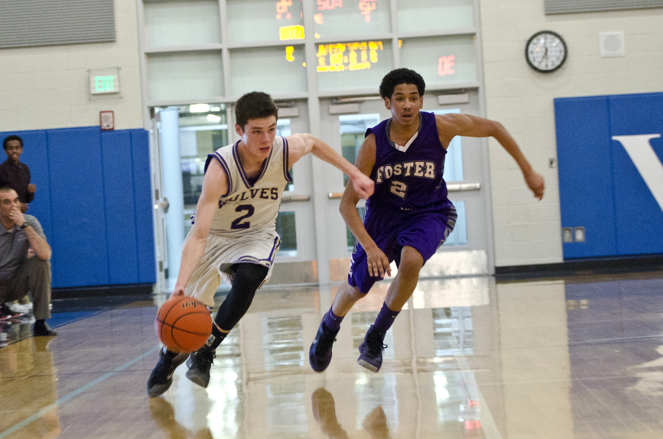 Sequim guard Anthony Pinza dribbles upcourt against the defense of Foster's Thomas Joseph. Jesse Major/for Peninsula Daily News
