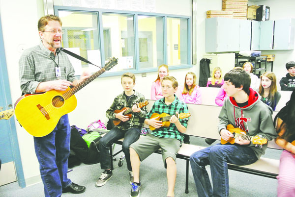 Blue Heron Middle School music teacher Bruce Cowan leads