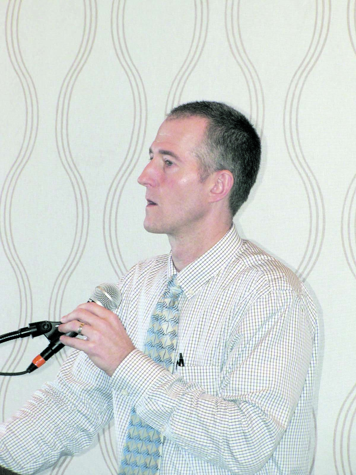Olympic Peninsula YMCA CEO Kyle Cronk speaks to the Port Angeles Regional Chamber of Commerce on Monday to pitch the 2012 Power of Community Campaign. Arwyn Rice/Peninsula Daily News