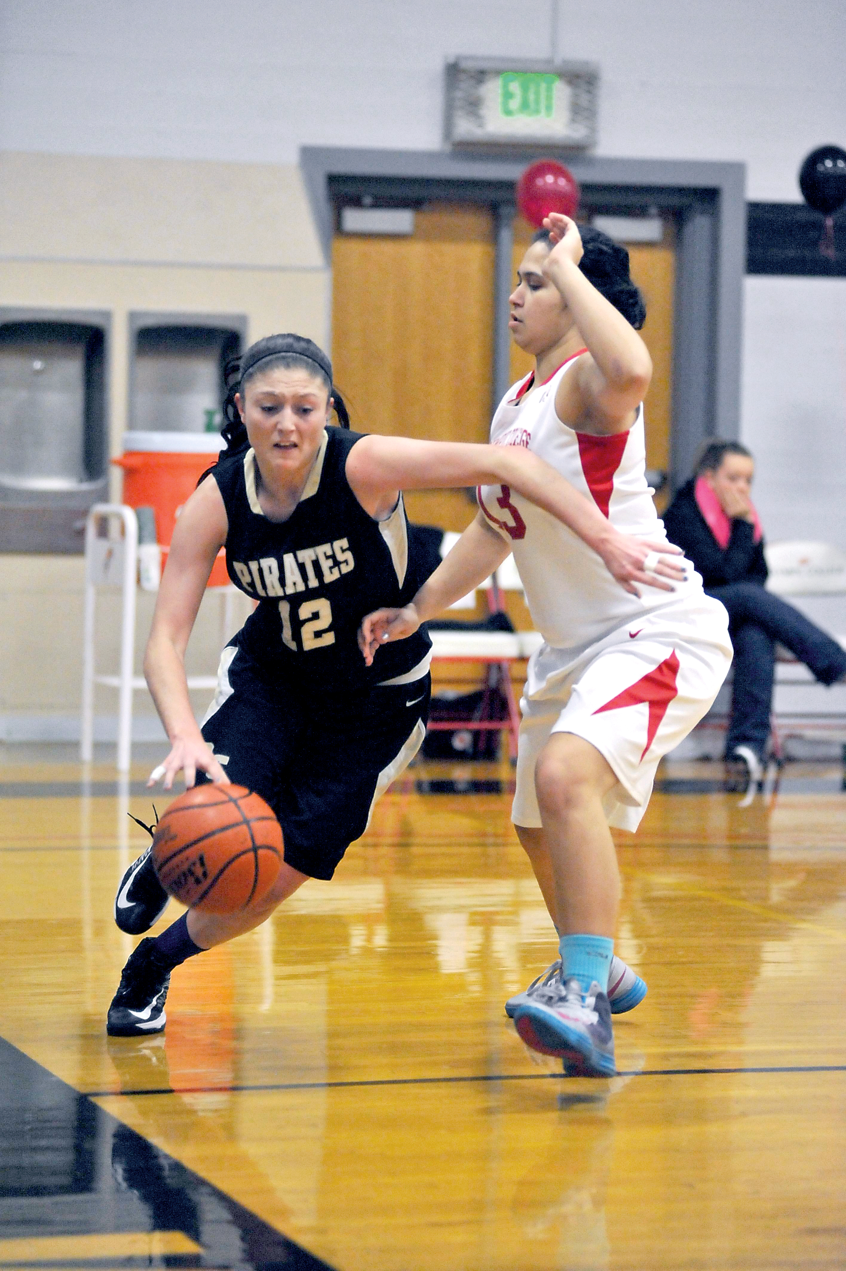 Peninsula's Madison Pilster drives past Olympic's Leahi Lindsey. Jeff Halstead/for Peninsula Daily News