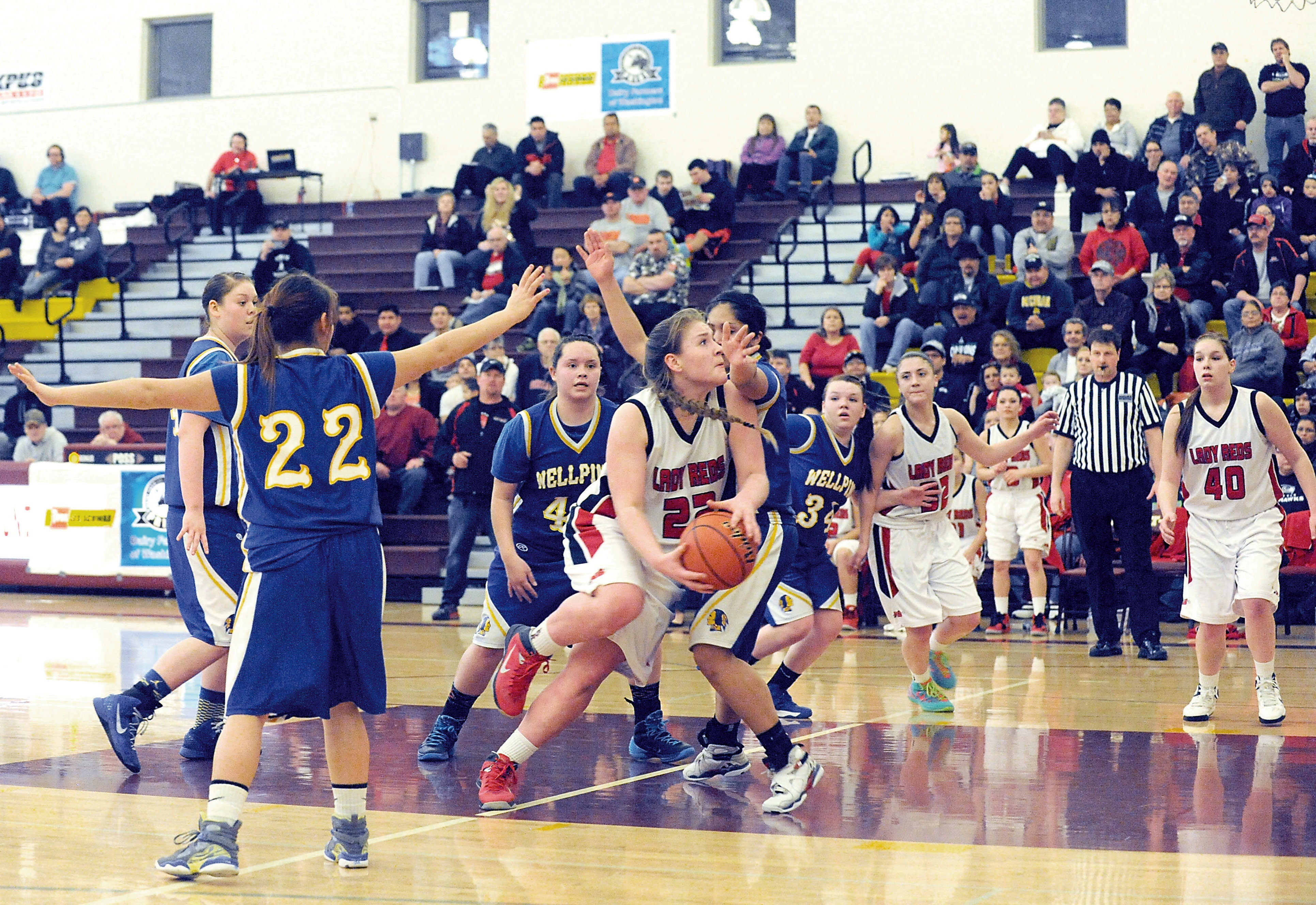 Neah Bay's Fay Chartraw (22) drives to the hoop against Wellpinit. Chartraw had a game-high 22 points. Lonnie Archibald/for Peninsula Daily News