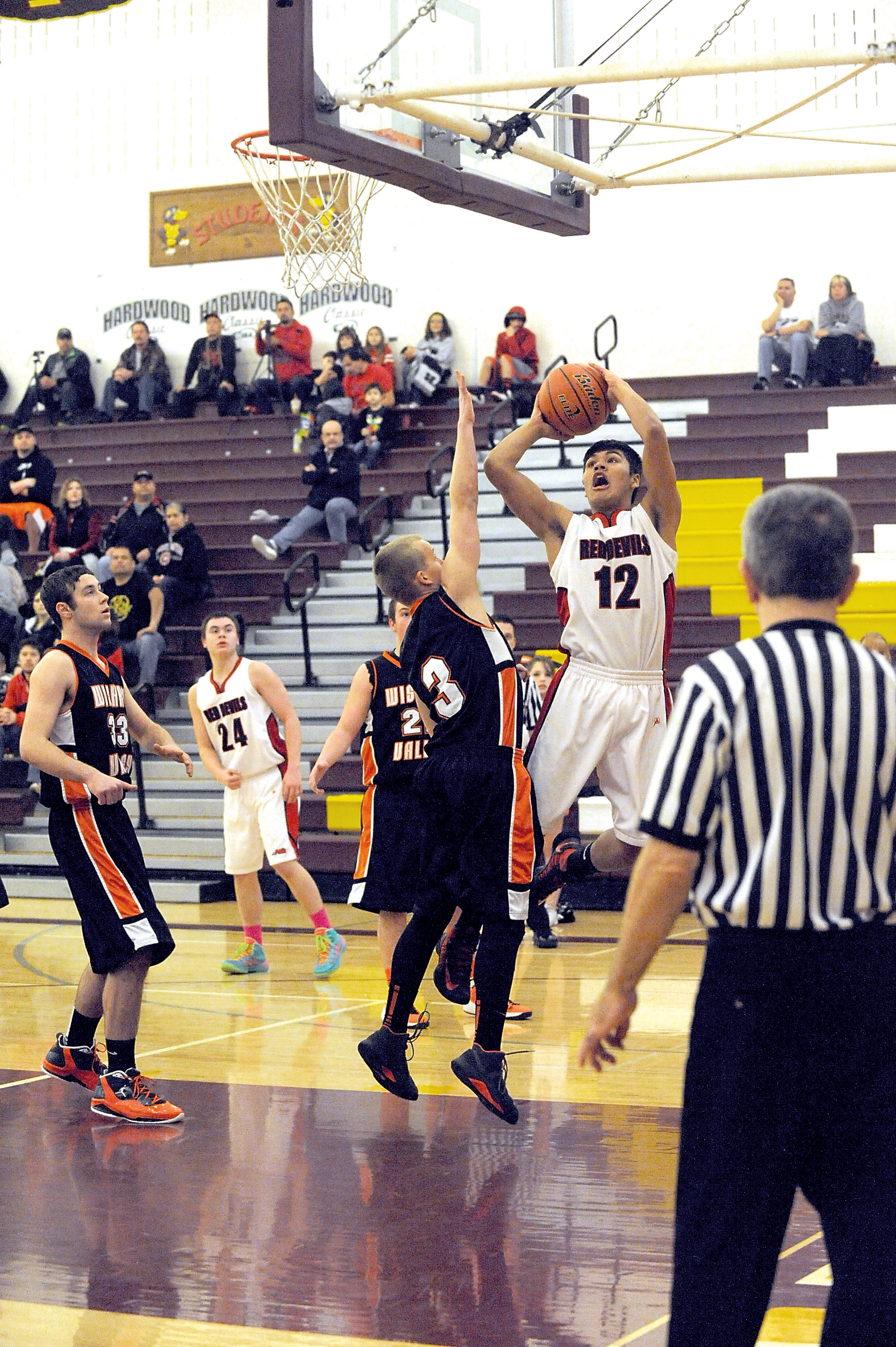 Neah Bay's Josiah Greene (12) puts up a shot over Wishkah Valley's Keigan Gardiner. Lonnie Archibald/for Peninsula Daily News