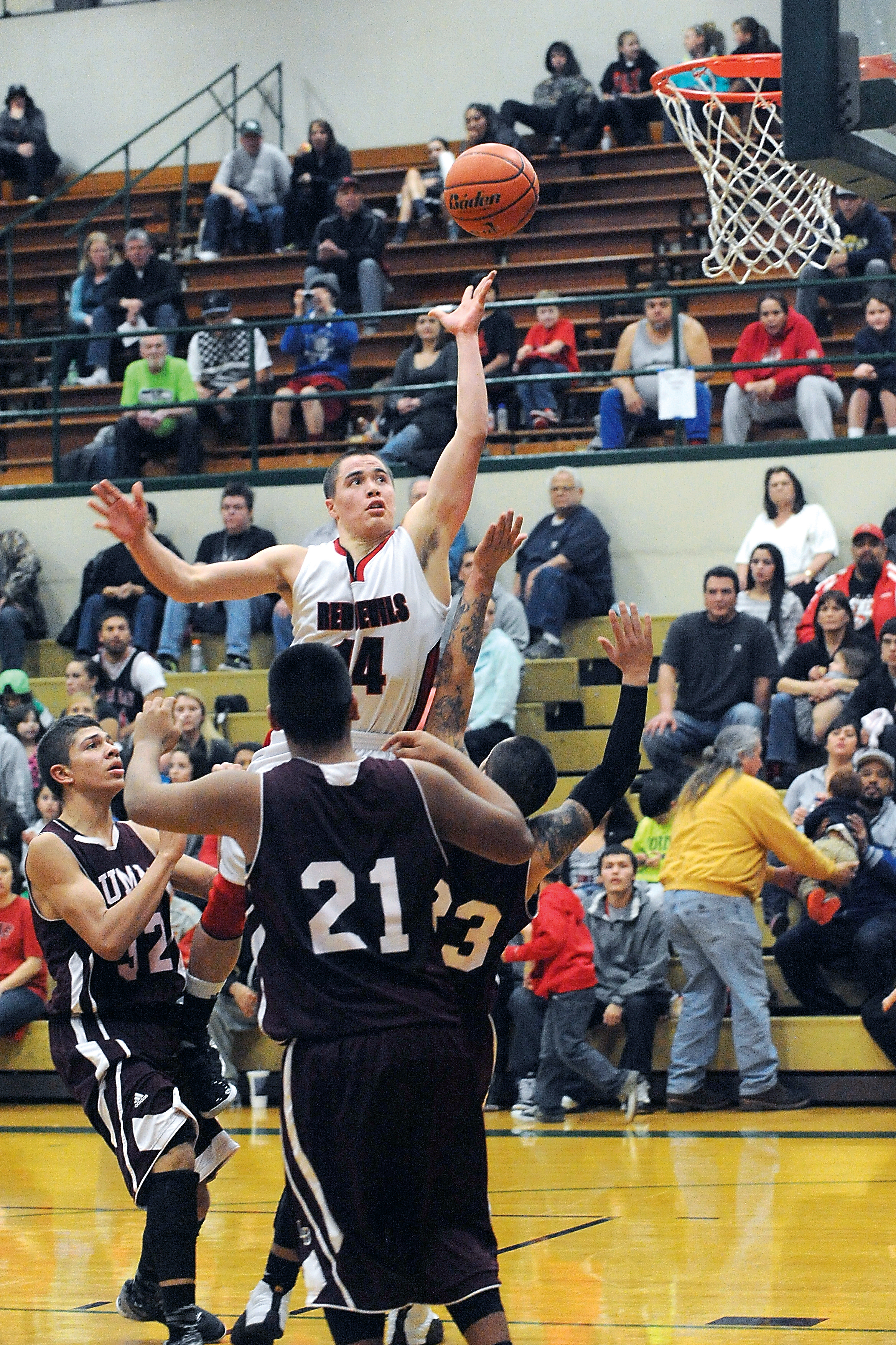 Neah Bay's Zeke Greene releases a shot amid a pack of Lummi defenders during the Tri-District playoffs at Port Angeles High School last month. Lonnie Archibald/for Peninsula Daily News
