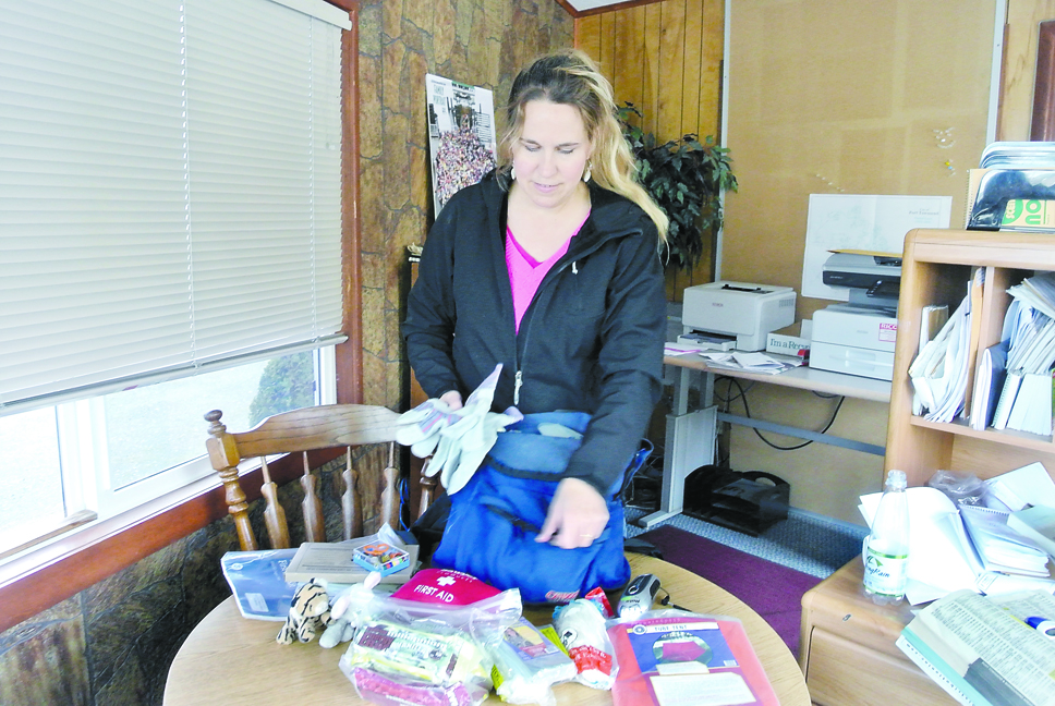 Heather Taracka shows off items in her emergency kit. Charlie Bermant/Peninsula Daily News