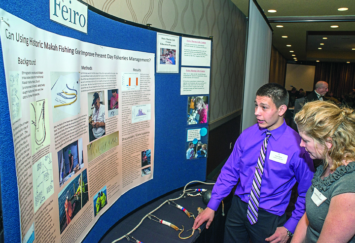 Makah tribal member Alex Wise discusses his halibut hook project with Jacqueline Laverdure