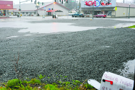 The empty lots of the International Order of Odd Fellows and Dazzled by Twilight buildings collect rain earlier this week. Lonnie Archibald/Peninsula Daily News