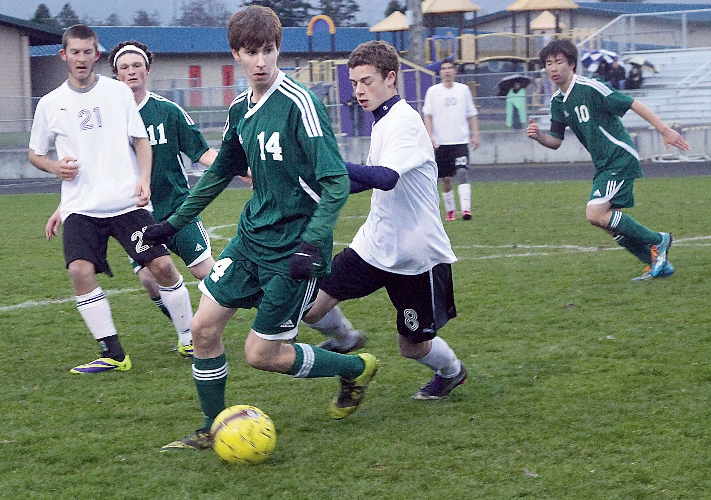 Port Angeles' Scott Methner and Sequim's Eli Berg battle for control of the ball at Sequim High School. Also in on the play is Cameron Chase (21) of Sequim and Vincent Ioffrida (11) and Wei-Yen Fu (10) of Port Angeles. Dave Logan/for Peninsula Daily News