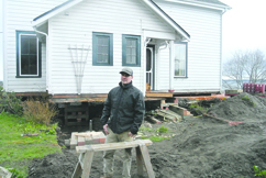 Contractor Brent Davis marks the spot for the corner of the new foundation for the historical house he is moving on Jefferson Street in Port Townsend. Charlie Bermant/Peninsula Daily News