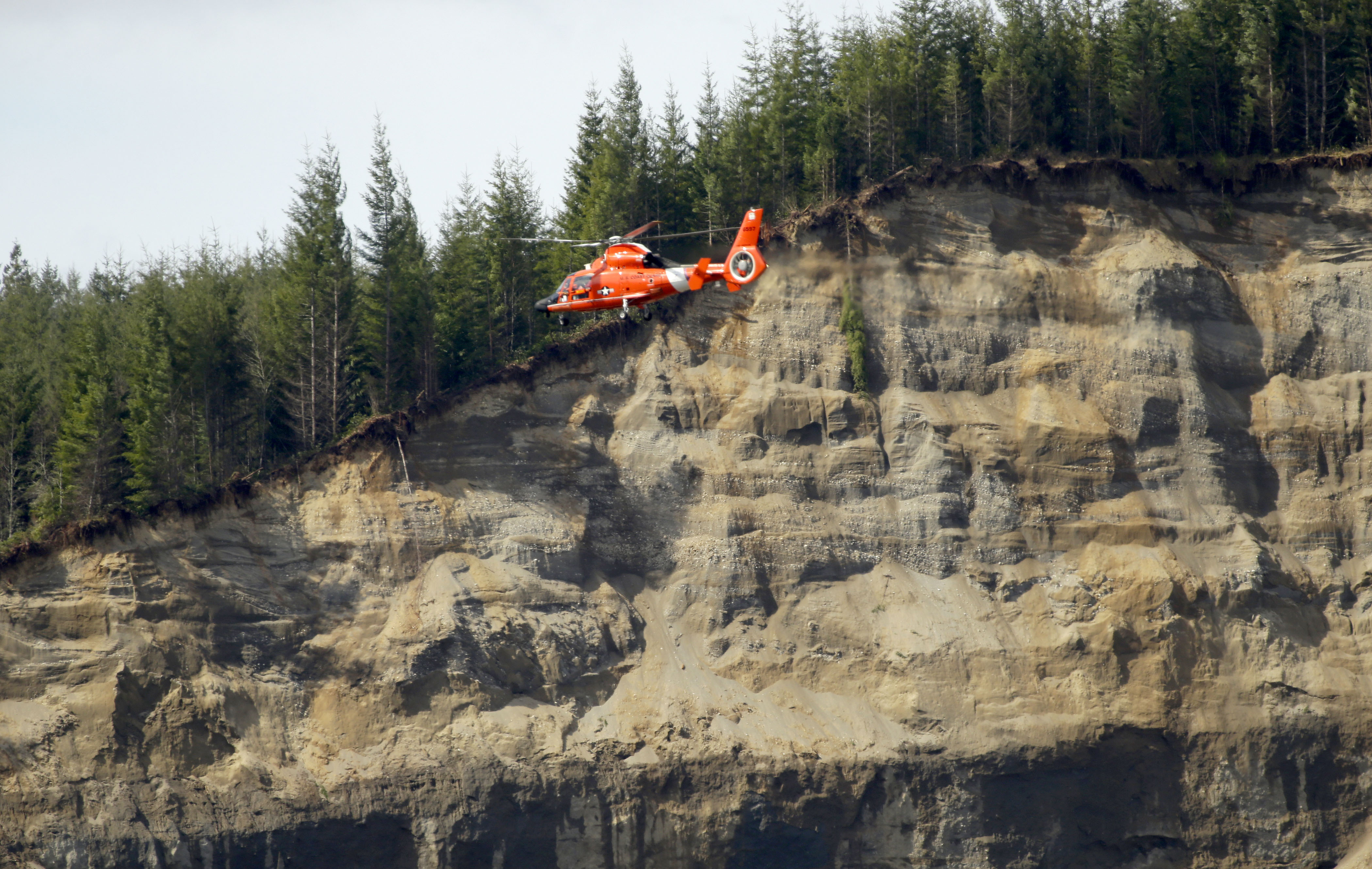 A Coast Guard MH-65 Dolphin helicopter from the Port Angeles air station