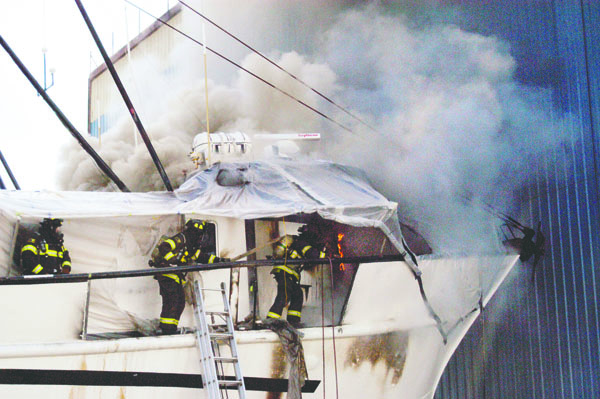 Firefighters battle a blaze and acrid smoke at the converted fishing vessel