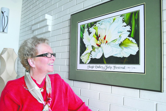 Karen Sistek shows off her poster for the 2013 Skagit Valley Tulip Festival. Keith Thorpe/Peninsula Daily News
