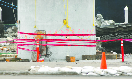 Warning tape surrounds the base of the Peninsula Plywood chimney stack