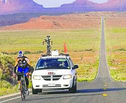 Bicyclist Pius Achermann crosses Monument Valley