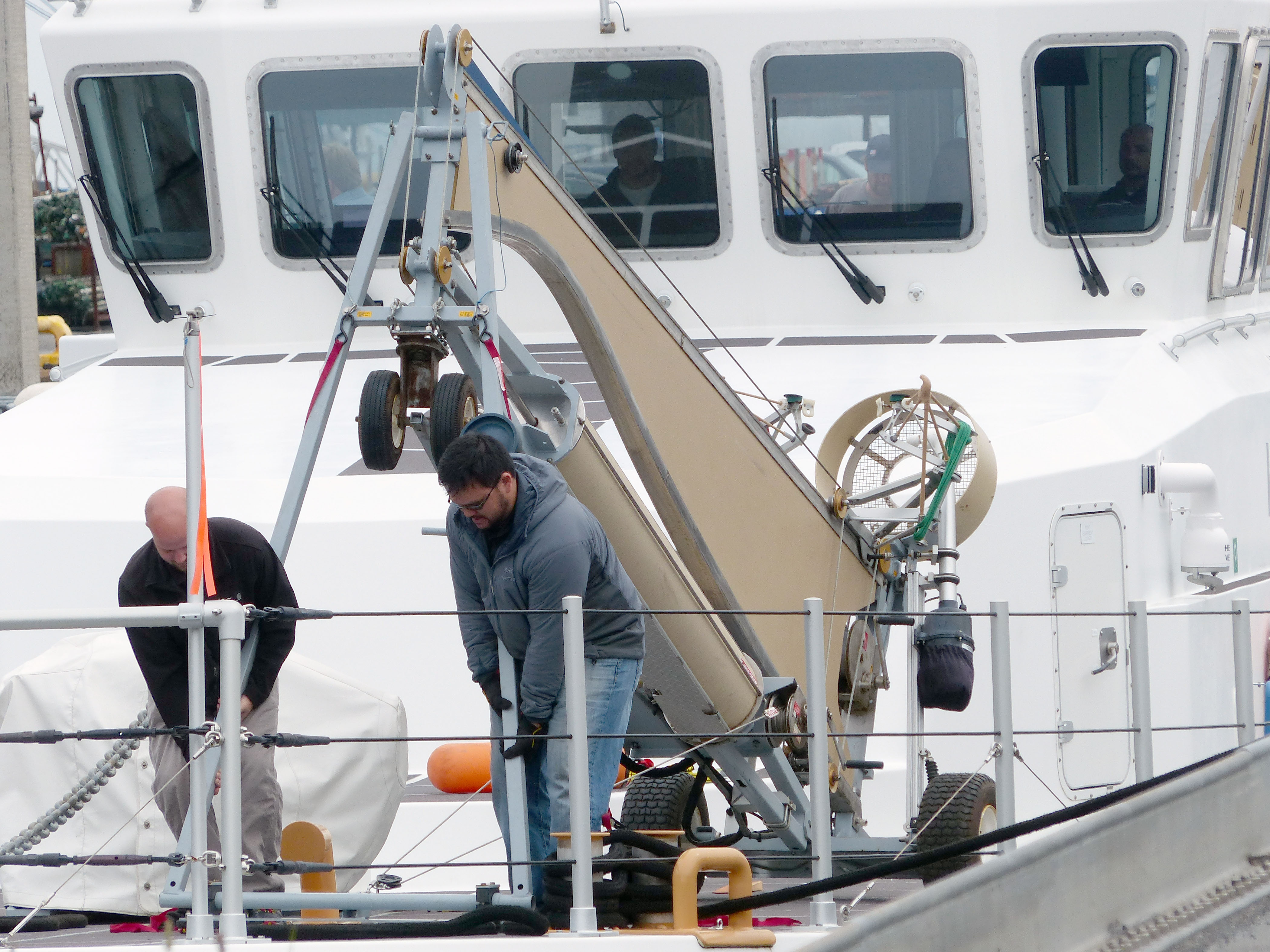 Contract workers install an unmanned-aircraft system aboard Westport Shipyard’s Solution at Port Angeles Boat Haven. —Photo by David G. Sellars/for Peninsula Daily News
