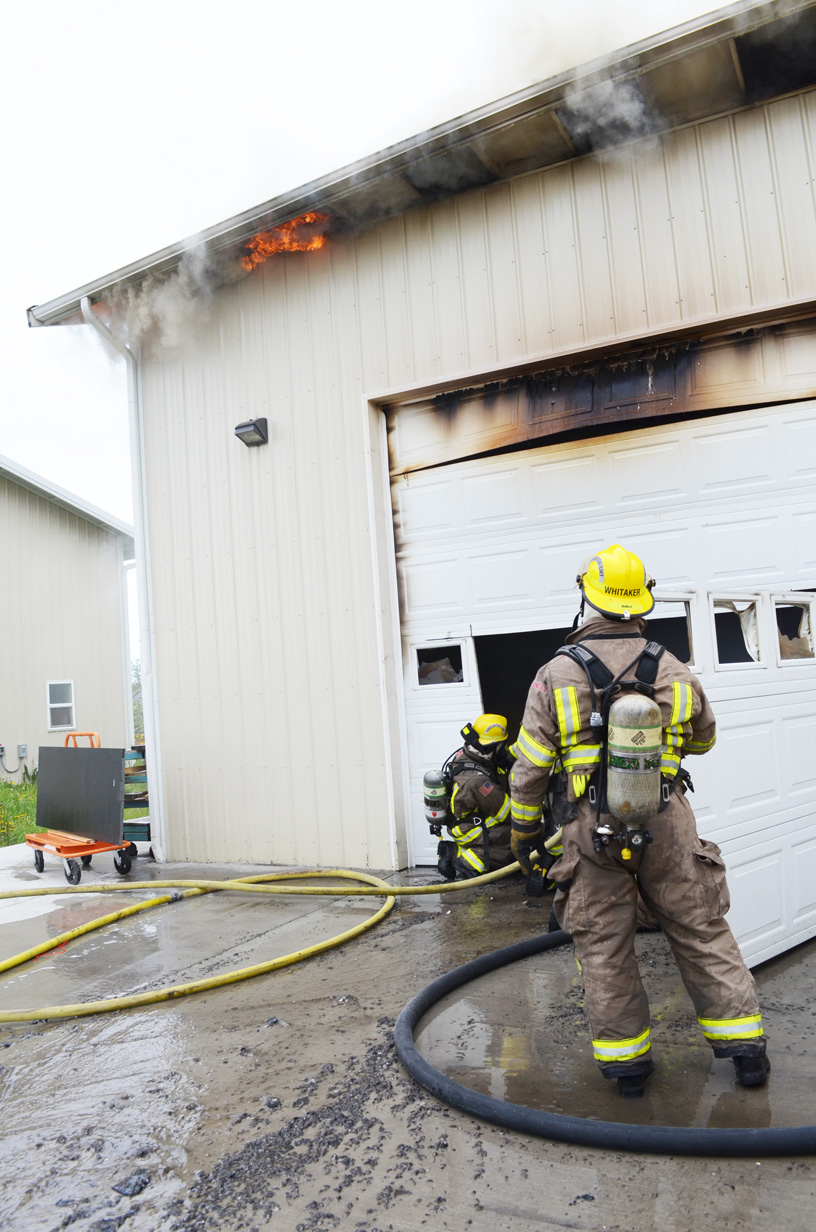 Clallam County Fire District No. 3 firefighters attack a blaze at 160 Banana Way in Carlsborg on Saturday. Patrick Young/Clallam County Fire District No. 3