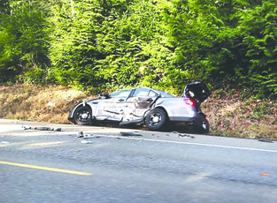 A Jefferson sheriff deputy's patrol car is seen after a wreck March 17 on U.S. Highway 101 south of Quilcene. Brian Lewis