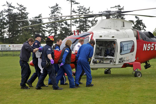 Personnel from Air Lift Northwest and East Jefferson Fire-Rescue personnel carry Austin Bishop